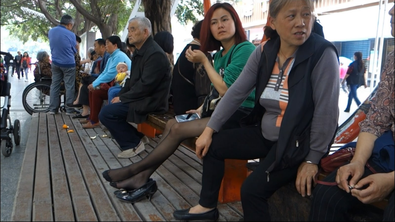 Woman with Black Nylon Waiting Someone and See Arround Her.